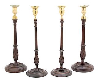 Two Pairs of Regency Brass Mounted Mahogany Candlesticks Height of tallest pair 15 1/2 inches.
