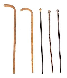A Group of Five Walking Sticks Length of longest 39 inches.