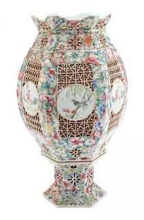 A Chinese Famille Rose Porcelain Reticulated Lantern Height 15 1/2 x diameter 8 1/2 inches.