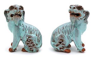 A Pair of Chinese Turquoise Glazed Pottery Foo Dogs Height 7 1/2 inches.