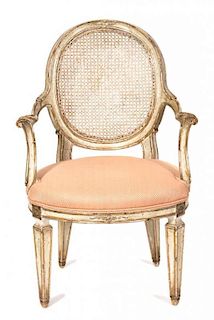 A Directoire Style Parcel Gilt Caned Oval Back Fauteuil Height 36 1/2 inches.