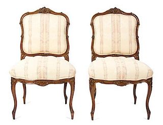 A Pair of Louis XV Style Carved Walnut Chaises Height 37 1/2 inches.