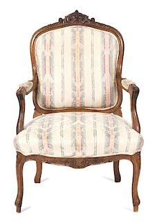 A Louis XV Style Carved Walnut Fauteuil Height 37 inches.