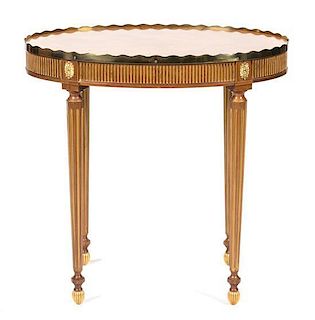 A Louis XVI Style Inlaid Walnut and Parcel Gilt Oval Side Table Height 27 x width 27 1/2 x depth 18 inches.