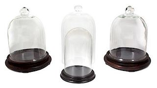 A Collection of Four Glass Domes Height of tallest 18 1l/2 inches.
