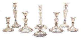 A Collection of Eight Silver Weighted Candlesticks Height of tallest 8 1/2 inches.