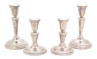 Two Pairs of Silver on Copper Candlesticks Height of taller pair 7 3/4 inches.