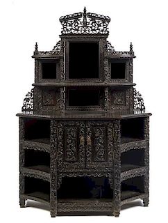 A Chinese Carved Hardwood Etagere, Height 71 x width 47 1/2 x depth 20 3/4 inches.