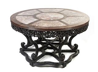 A Chinese Carved Hardwood, Marble and Brass Inset Center Table, Height 30 1/4 x diameter 55 inches.