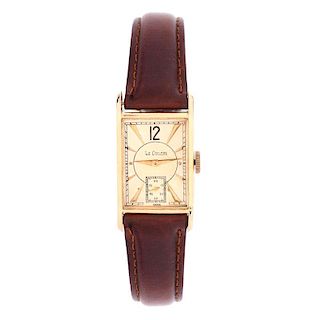 Lady's Vintage LeCoultre 14 Karat Yellow Gold Tank Watch with Leather Strap. Case measures 27mm x 2