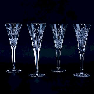 Four (4) Tall Waterford Crystal Champagne Flutes. Signed. One has hairline to rim otherwise good co
