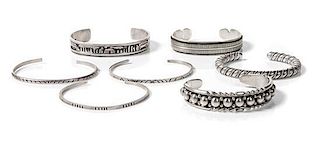 Seven Navajo Silver Bracelets Length of one 5 3/4 x opening 1 3/8 x width 1/4 inches