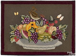 American hooked rug with bowl of fruit