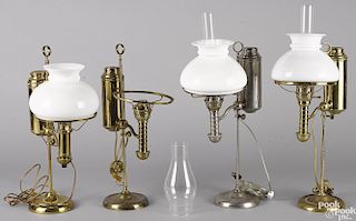 Four brass single-arm student lamps