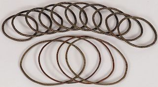 A GROUP OF TEN BRASS AND COPPER BANGLES
