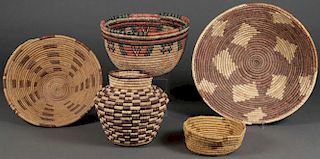 A GROUP OF FIVE WOVEN BASKETS