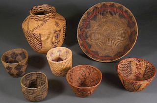 A GROUP OF SEVEN LARGE WOVEN BASKETS