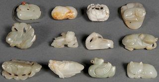 A GROUP OF TWELVE CHINESE CARVED JADE PENDANTS