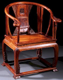 A CHINESE CARVED ELMWOOD ARM CHAIR