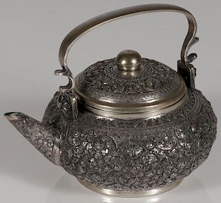 A CONTINENTAL SILVER REPOUSSÉ AND CHASED TEAPOT