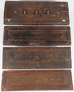 FOUR TIBETAN CARVED WOOD SUTRA COVERS