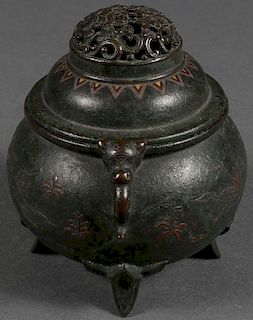 A BRONZE AND MIXED METAL FOOTED INCENSE BURNER