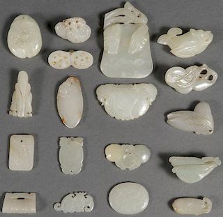 A GROUP OF EIGHTEEN CHINESE CARVED JADE PENDANTS
