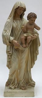A CAST POLYCHROME FIGURE OF THE MADONNA AND CHILD
