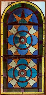 A PAIR OF ARCHED STAINED AND LEADED WINDOW PANELS