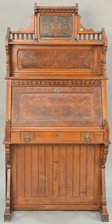 Victorian walnut and burl walnut desk with putti inlaid top and floral inlay over lid with two side doors. ht. 67 1/2 in., wd