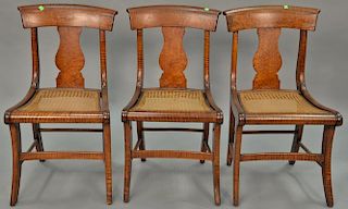 Set of three tiger maple cane seat chairs, circa 1840.