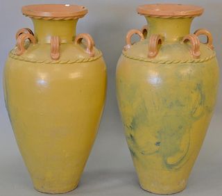 Pair of large earthenware urns (chips, two handles broke off). ht. 37 in.  Provenance: From the Estate of Faith K. Tiberio of