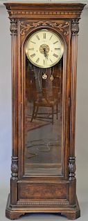 Howard Miller tall clock with three brass weights and pendulum. ht. 89 in., wd. 31 in.