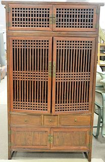 Chinese style cabinet in two parts having six doors and three drawers. ht. 86 in., wd. 48 in.