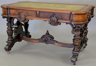 Walnut Victorian double writing table with carved medallion pulls and lion faces on ends and original felt surface. ht. 29 1/