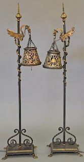 Pair of iron floor lamps with bird hangers and iron reticulated shades. ht. 50 in. Provenance: From the Estate of Faith K. Ti