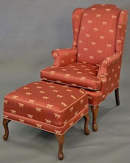Queen Anne style upholstered wing chair and ottoman in custom silk upholstery (slight cat scratches).  Provenance: From the E
