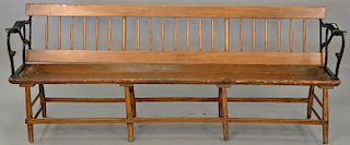 Railroad plank seat bench with iron arms and reversible back. lg. 84 in.  Provenance: Property from the Estate of Frank Perro