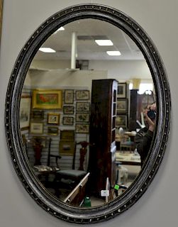 Silver framed oval mirror mounted with faceted glass (two small glass pieces missing). 44" x 35"   Provenance: From the Estat