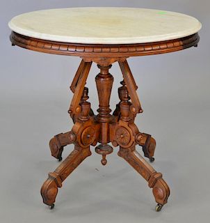 Victorian walnut oval marble top table. top: 24" x 31"