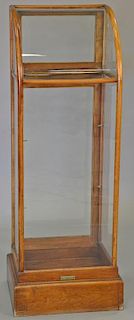 Two piece lot to include an oak store display on stand (ht. 41 in., top: 16" x 18") and store display cabinet with curved gla