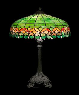 * Wilkinson Co., EARLY 20TH CENTURY, a leaded glass table lamp, the domed shade with floral lower border, raised on a cast me