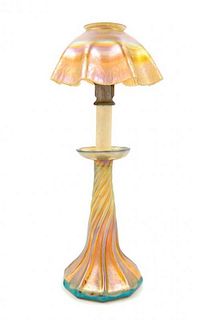 Tiffany Studios, EARLY 20TH CENTURY, a Favrile glass candlestick lamp, in gold iridescence, having ruffled shade and twist ba