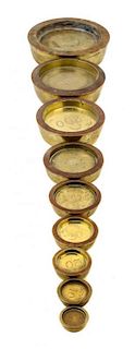 * A Set of Nine Brass Sovereign Weights Diameter of largest 6 inches.