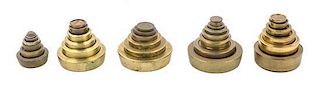 * Five Sets of Brass Weights Diameter of widest 2 7/8 inches.