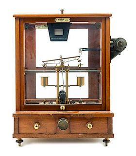 * An English Mahogany Cased Brass Assayer's Balance Height of case 19 1/2 x width 14 1/2 x depth 10 1/2 inches.