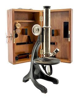 * A German Nickel-Plated and Black Lacquered Microscope Height 12 inches.