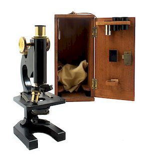 * An English Brass and Black Lacquered Microscope Height 11 inches.