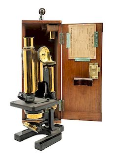* An English Brass and Black Lacquered Microscope Height 11 inches.