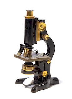 * An English Brass and Black Lacquered Microscope Height 12 inches.